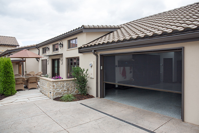 Garage door opening shown with a lowered retractable screen